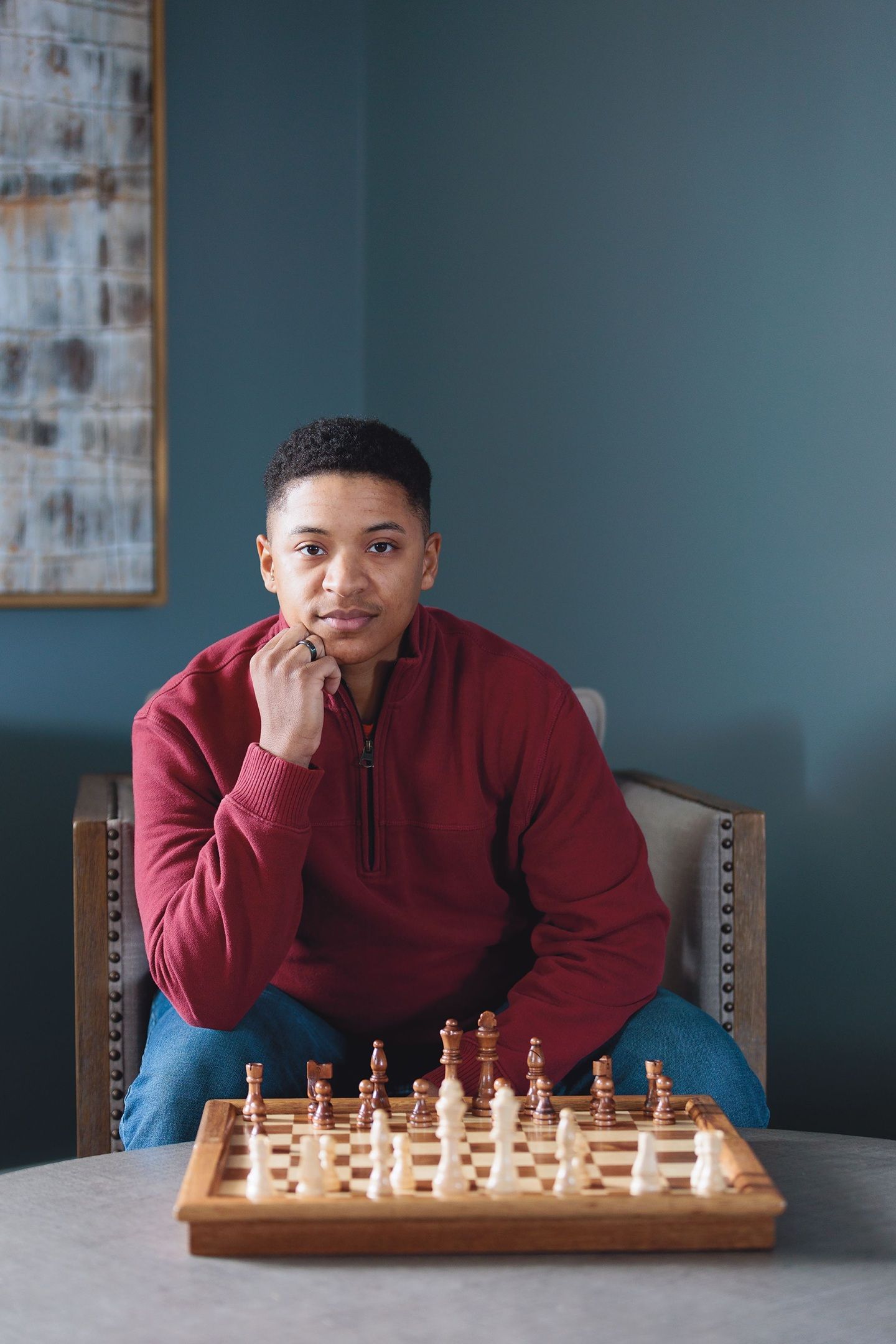 A man who lives with MS looks out across a chess board.