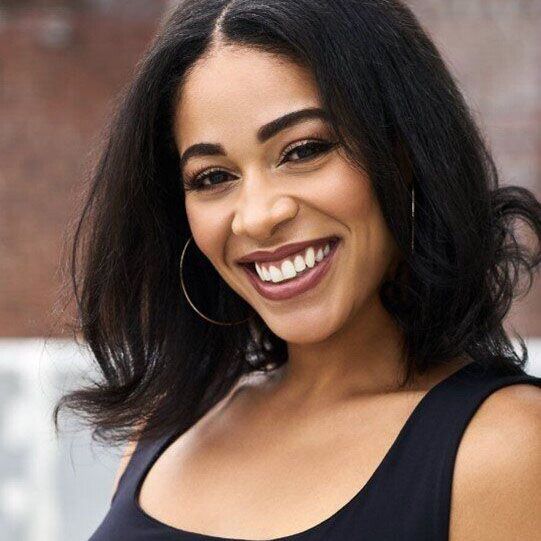 Victoria, a woman with MS, smiles.