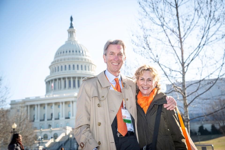  Bill Onufrychuk and his wife, Cathy, hugging each other in front of the US Capitol in Washington, D.C.