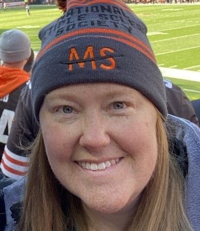 Close-up of Kristen Gerhardt, who lives with MS, wearing a National MS Society hat.