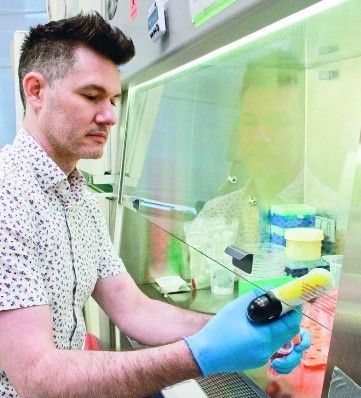 An MS researcher concentrates as he works in a lab. 